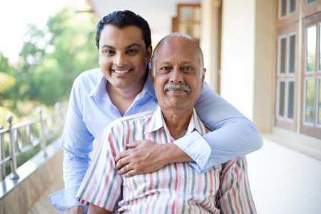 Son holding his father on a wheelchair at Hope Hospice end-of-life care