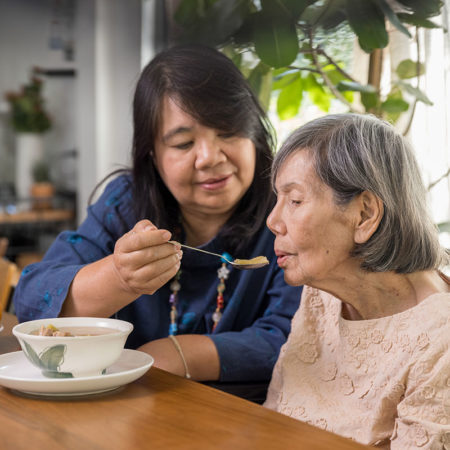 assisted feeding of an elderly woman