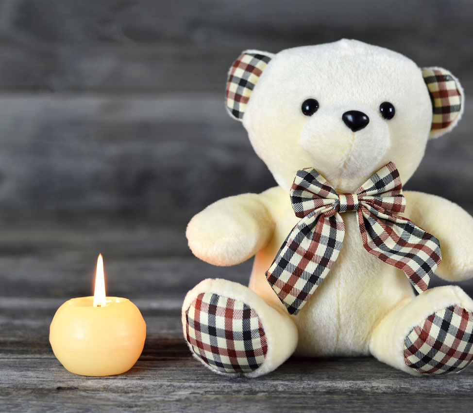 A teddy bear and a candle